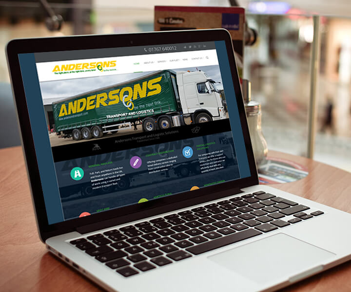 laptop displaying Andersons Transport websites homepage, including a picture of a lorry